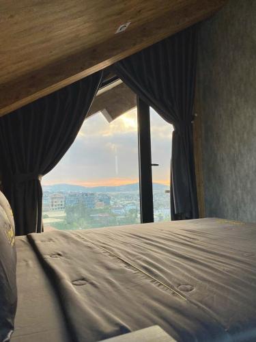 a bedroom with a bed with a view at Hồ Bơi Vô Cực - Có Thể Săn Mây Tại Giường in Da Thanh