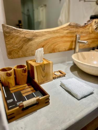 a bathroom counter with a wooden cutting board and a sink at Muraka Dhigurah in Dhigurah