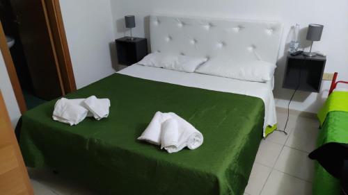 a bedroom with a bed with two towels on it at Residence Punta Cilento in Pisciotta