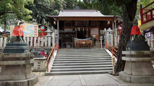a stairway leading to a temple with a building at U-Community Hotel in Osaka