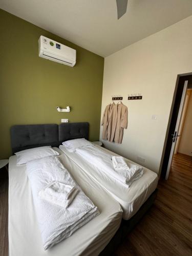 a bedroom with a bed with towels on it at Smart Comfort RoomN7 with Private Bathroom in best Location Beach 250m in Limassol