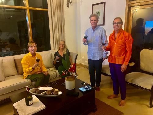a group of people standing in a living room holding wine glasses at Star Light Tropical Villa in Bentota
