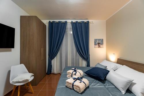 a bedroom with a large bed with blue curtains at Torre dei Venti in Ceccano