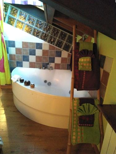 a bath tub in a room with a tiled wall at La Fuente in Umbrías