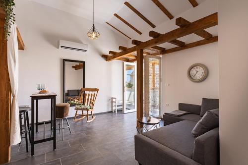 a living room with a couch and a table at Summer cottage 1 in Novalja