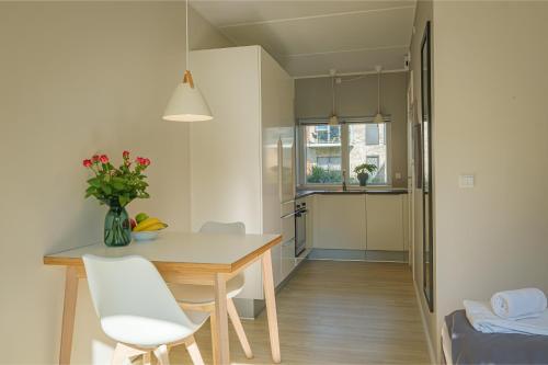 a kitchen and dining room with a table and chairs at Aalborg Hotel Apartments in Aalborg