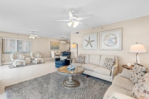 a living room with a couch and a table at Sunrise 109 in New Smyrna Beach