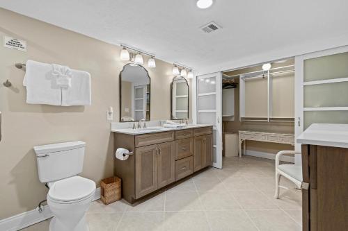 a bathroom with a toilet and a sink at Sunrise 109 in New Smyrna Beach