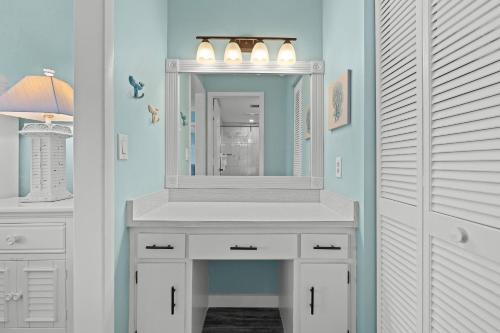 een badkamer met een witte wastafel en een spiegel bij The Shores Club 1105 in Daytona Beach