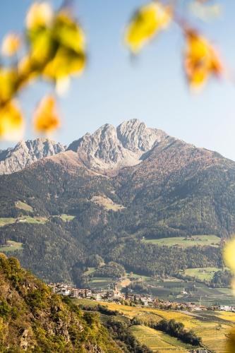 a snow covered mountain in the distance with a town at Plarserhof in Lagundo