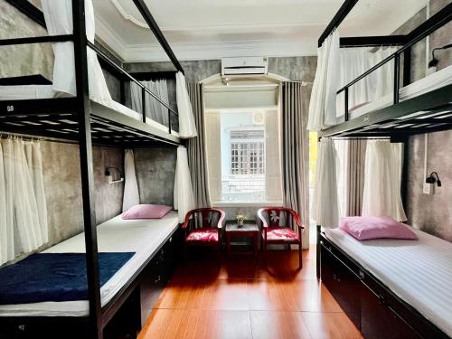 Ένα ή περισσότερα κρεβάτια σε δωμάτιο στο Amy Hostel Hue