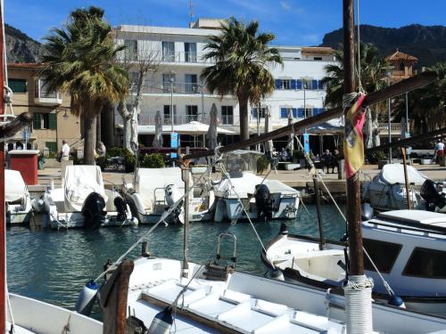a group of boats docked in a marina with palm trees at Hotel Miramar in Port de Soller