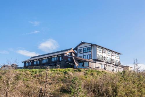 a large building on top of a hill at Ichiboukan Hanare Kai in Kyotango