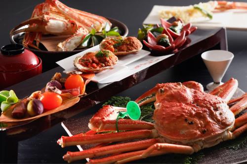 a table topped with different types of food on plates at Ichiboukan Hanare Kai in Kyotango