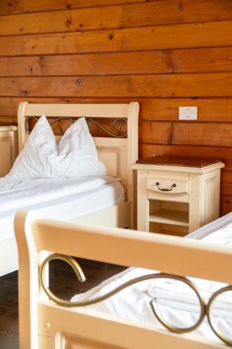 two bunk beds in a room with a night stand at LifeHarbour Limanu in Limanu