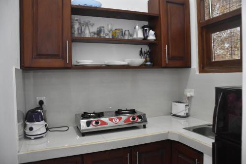 a kitchen with a stove top oven sitting on a counter at Cinnamon Mantra Luxury Villa in Beruwala