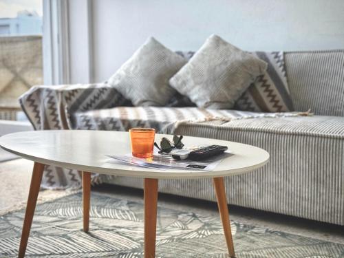 a coffee table in a living room with a couch at Yialos Village by Cybarco in Larnaca