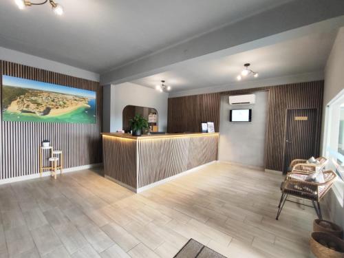 a lobby with a bar in a hotel room at Vilas Marrocha in Porches