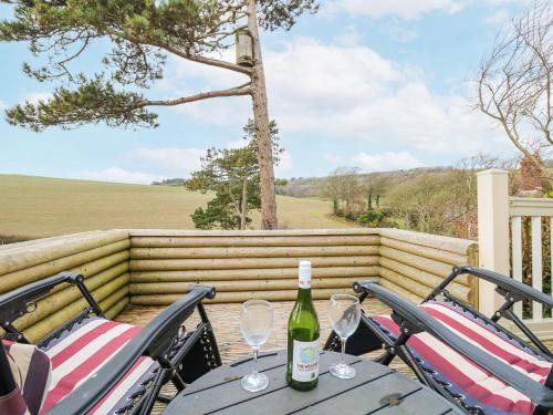 a table with two chairs and a bottle of wine at The Retreat in Newport