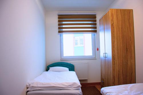 a small bedroom with a bed and a window at Sarajevo Gate in Sarajevo