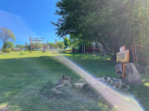a rainbow in a park with a playground at Penzion Pulčínské Skály in Pulčín