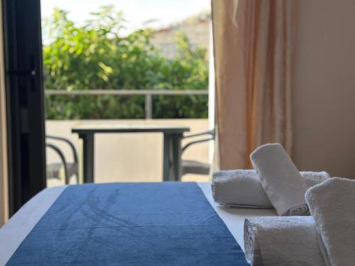 a table and chairs with a view of a balcony at Ion Sea View in Ksamil