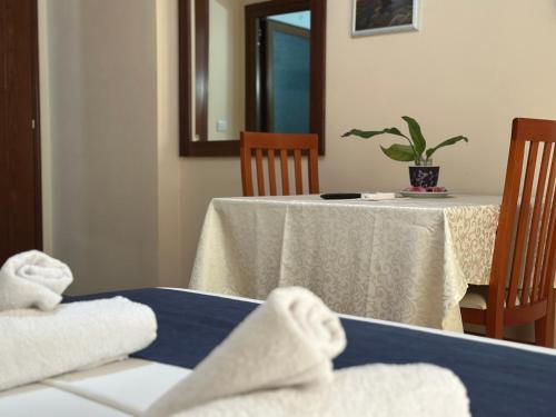 a table with towels on it with a plant on it at Ion Sea View in Ksamil