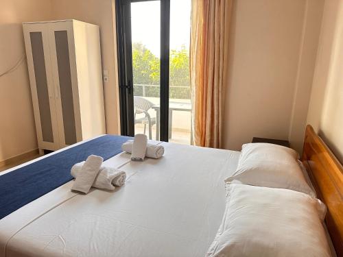 a bedroom with a bed with towels on it at Ion Sea View in Ksamil