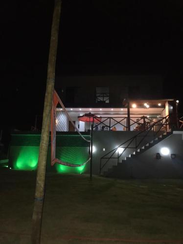 a building with green lights at night at Casa completa Porto Sauipe in Porto de Sauipe