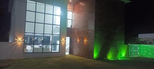 a building with green lights on the side of it at Casa completa Porto Sauipe in Porto de Sauipe