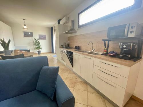 a kitchen with a couch and a sink and a counter at GIOIA'S HOUSE in Custonaci