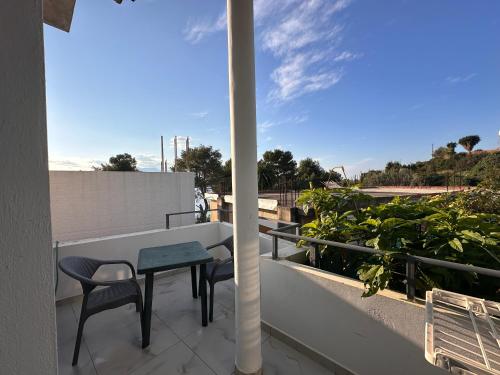 a balcony with a table and chairs on it at Ion Sea View in Ksamil