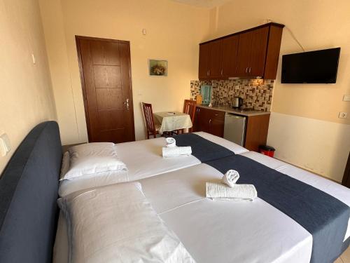 a bedroom with a large bed with towels on it at Ion Sea View in Ksamil