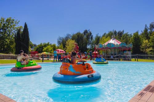 a group of people riding on tubes in a water park at Casa da Petisqueira 54, Paredes-Oporto in Rebordosa
