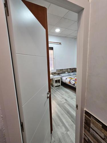 an open door to a room with a bed at Habitación doble con baño privado in Hospitalet de Llobregat
