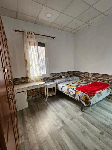 a bedroom with a bed and a desk and a window at Habitación doble con baño privado in Hospitalet de Llobregat