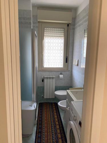a bathroom with two toilets and a sink and a window at Casa Sofia in Termoli