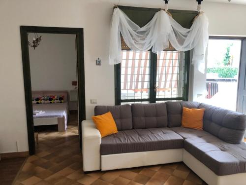 a living room with a couch and a mirror at Chira House in Santa Marinella