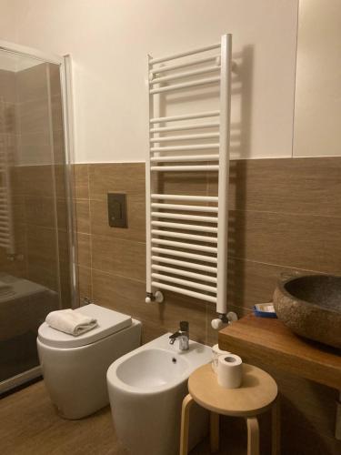 a bathroom with a white toilet and a sink at Bella Napoli Guesthouse Trattoria Pizzeria in La Spezia