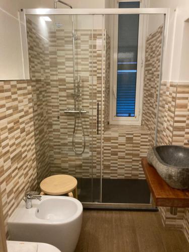 a bathroom with a shower and a toilet and a sink at Bella Napoli Guesthouse Trattoria Pizzeria in La Spezia