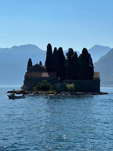 a house on an island in the middle of the water at Waterfront Historical Villa Perast in Perast