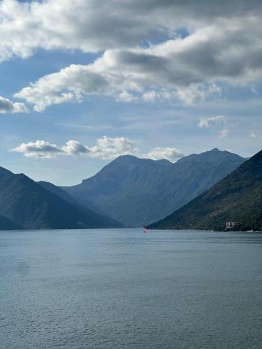 a large body of water with mountains in the background at Waterfront Historical Villa Perast in Perast