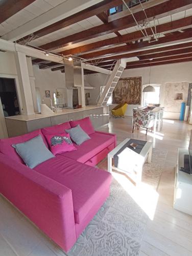 a living room with a pink couch and a table at Waterfront Historical Villa Perast in Perast
