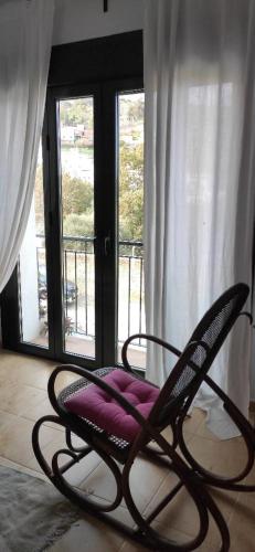 a chair sitting in a room with a window at Beautiful Duplex with a Patio in Alcalá de los Gazules