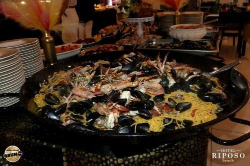 a large pan of food on a table with pasta at Hotel Riposo in Gatteo a Mare