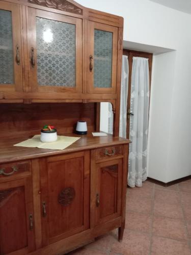 a wooden cabinet in a room with a door at Casa VACANZE LUSITANA C2 in Foligno