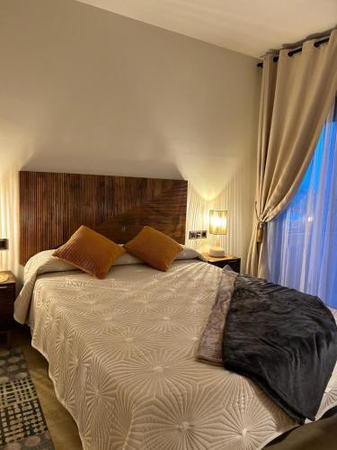 a bedroom with a large bed and a window at Sweet Home II in Manilva