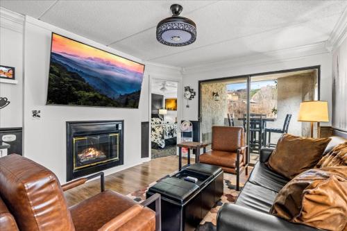 a living room with a couch and a fireplace at Corner Unit Balcony Free Tix LOCATION in Gatlinburg