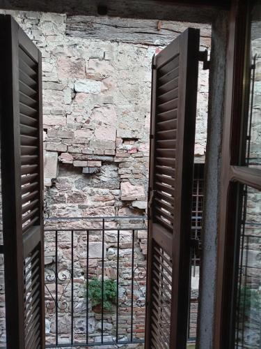an open door with a stone wall and a window at Casa VACANZE LUSITANA C2 in Foligno