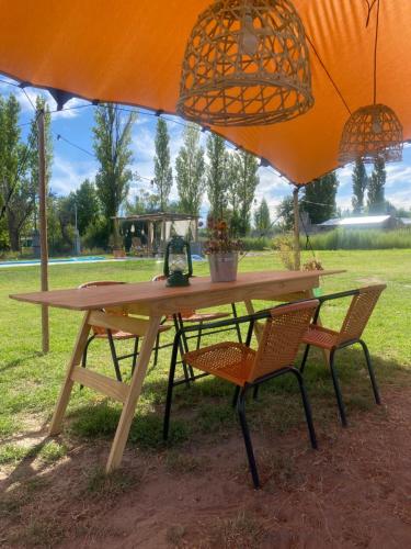 a picnic table with two chairs under an umbrella at containers house in San Rafael